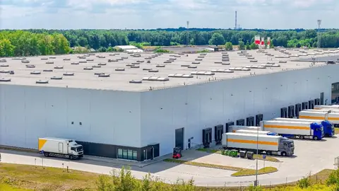 Logistics warehouse with lorries at the loading bays